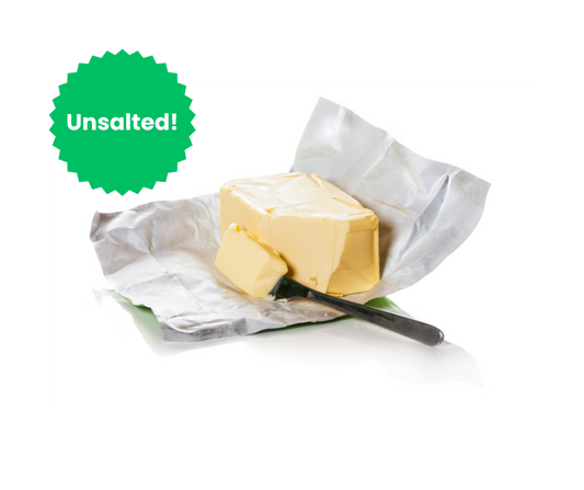 Unsalted butter block with a knife on a white background